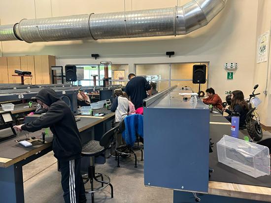 Students sitting and standing at lab tables in the Industrial technology Center.