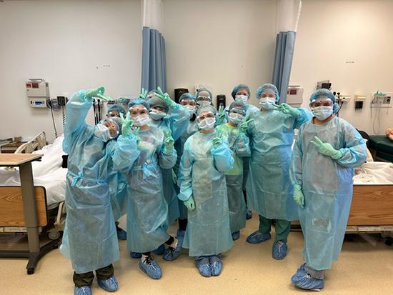 Nursing Exploration Project participants in a lab wearing healthcare worker gear.